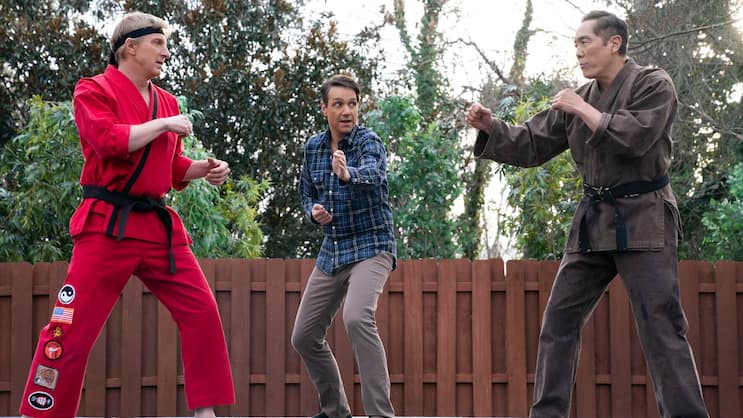 Johnny Lawrence (William Zabka, l.), Daniel LaRusso (Ralph Macchio, M.) und Chozen (Yuji Okumoto, r.) bringen sich zum allerletzten Mal in Kampfpose.